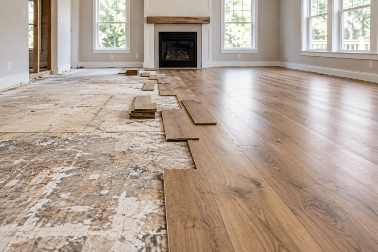 Flooring installation transitioning from rough subfloor to finished wood floor
